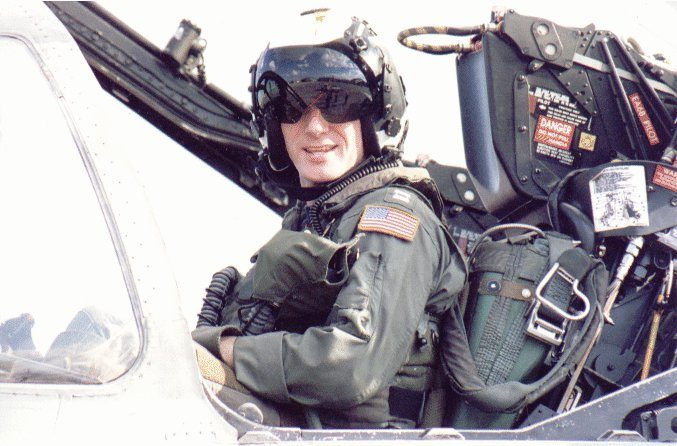 Chris Ognek in flight gear and helmet, smiling from the cockpit of an EA-6B Prowler
